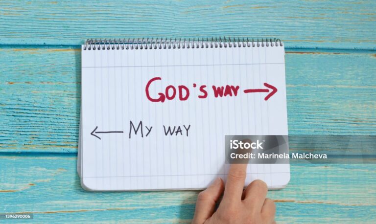 God's way, message quote on a notebook with a hand showing in direction to handwritten arrow isolated on a light blue wooden background. Top view. Follow Jesus Christ's path of eternal life concept.