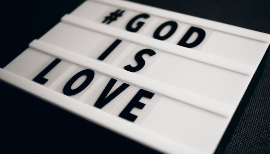 Close-up of a light box displaying '#God is love', promoting spirituality.