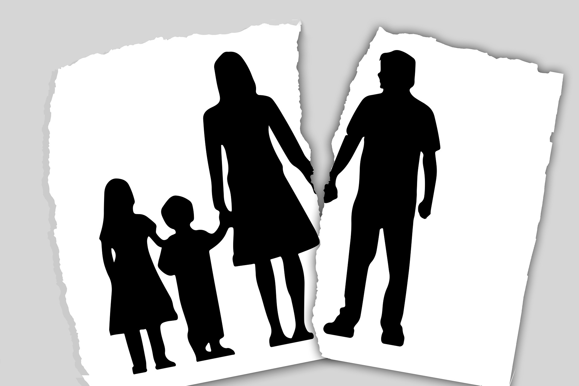 A torn image depicting silhouettes of a family holding hands, symbolizing separation or divorce, emphasizing the theme of family dynamics.