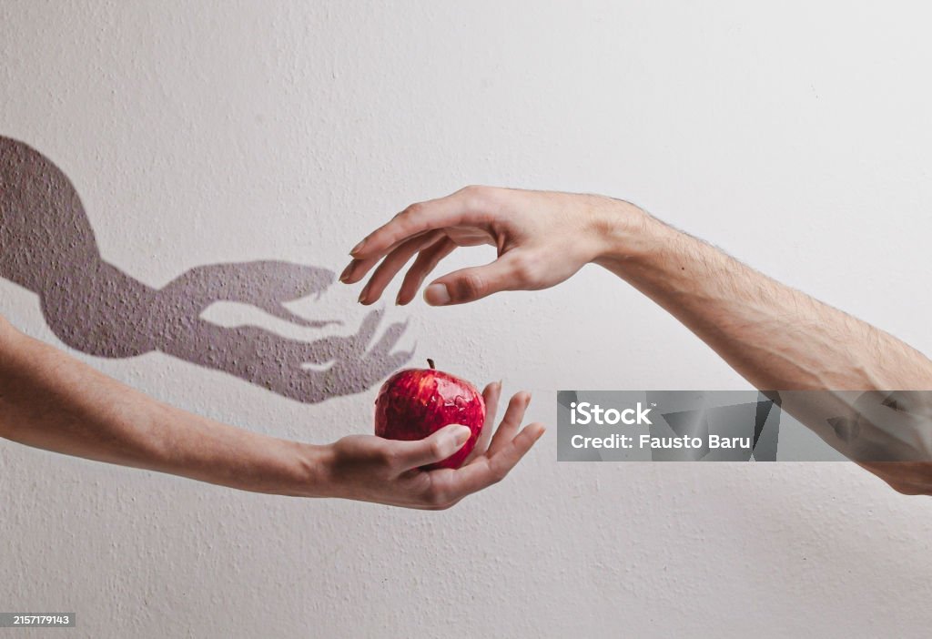 Two hands are extended: the woman's hand offers a red apple to the man's hand. The shadow cast by his hand shows a snake instead of the apple. Genesis 3:1-6 Eve, Adam, Lilith. The original sin.